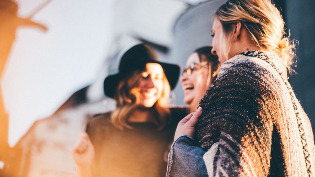 Building Healthy Relationships after Trauma: 3 women smiling in a small group together